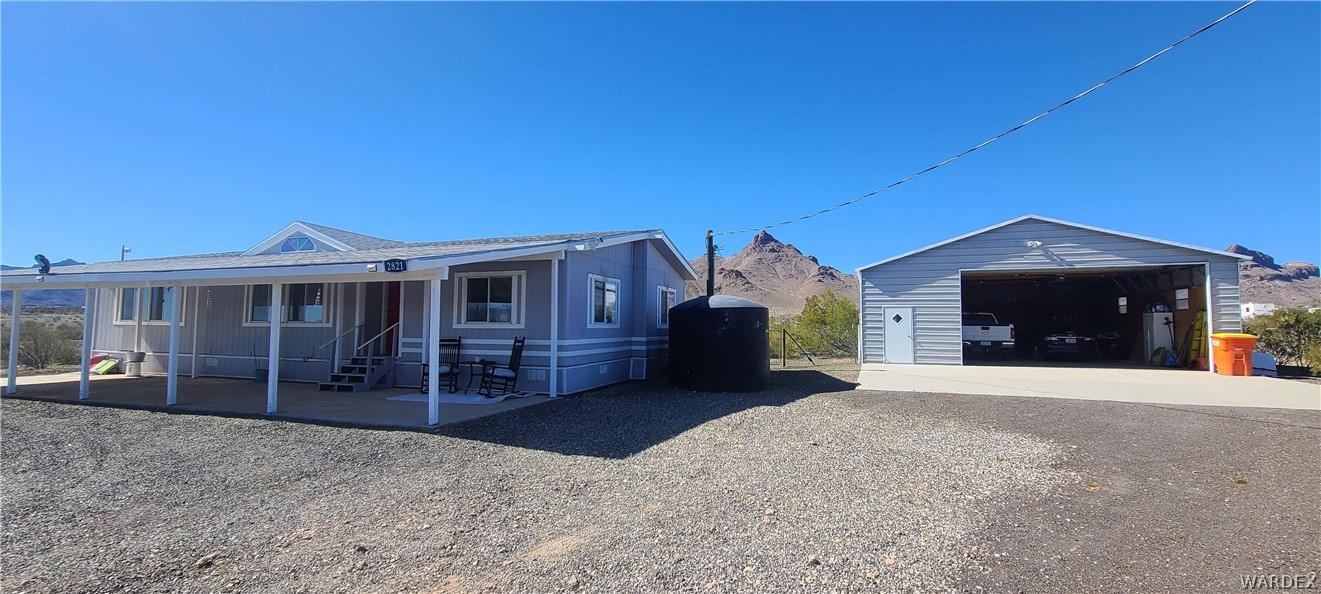 2821 Naco Road Golden Valley, AZ 86413 - Photo 1 of 71 a front view of a house with a yard and garage