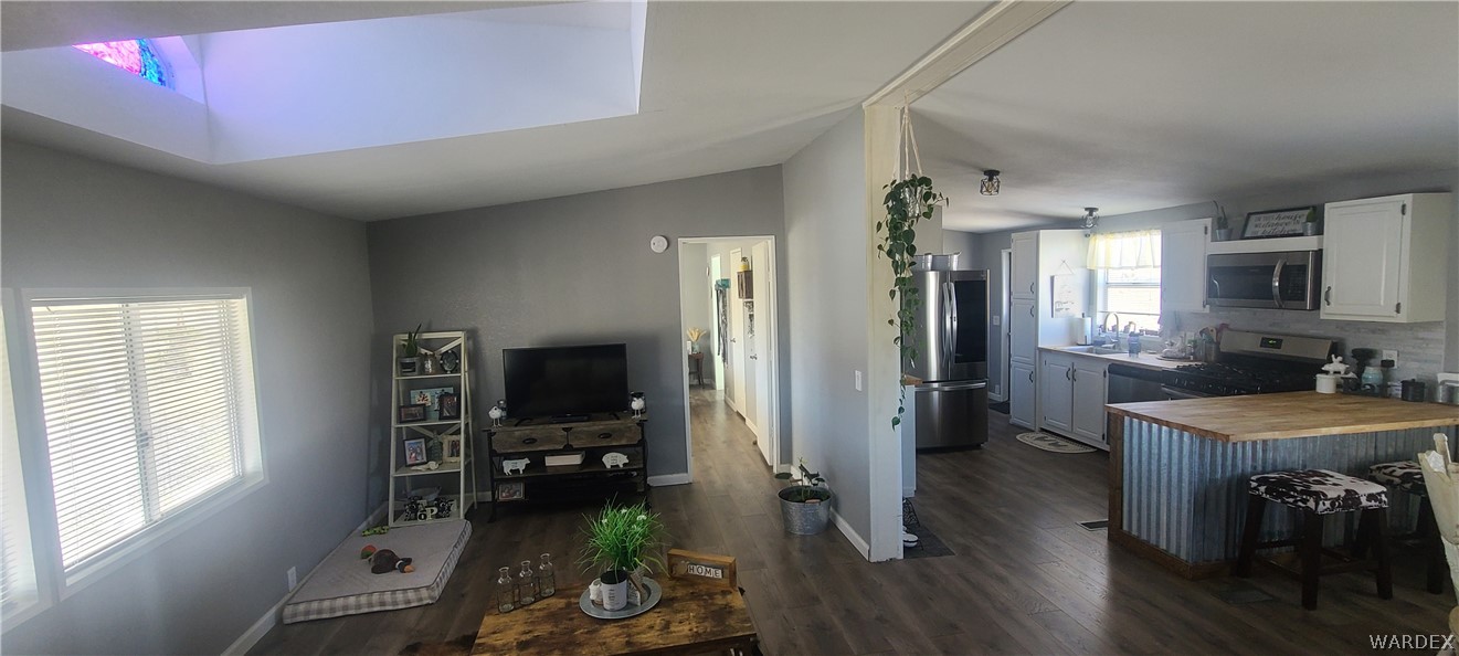 2821 Naco Road Golden Valley, AZ 86413 - Photo 16 of 71 a living room with furniture a flat screen tv and a table