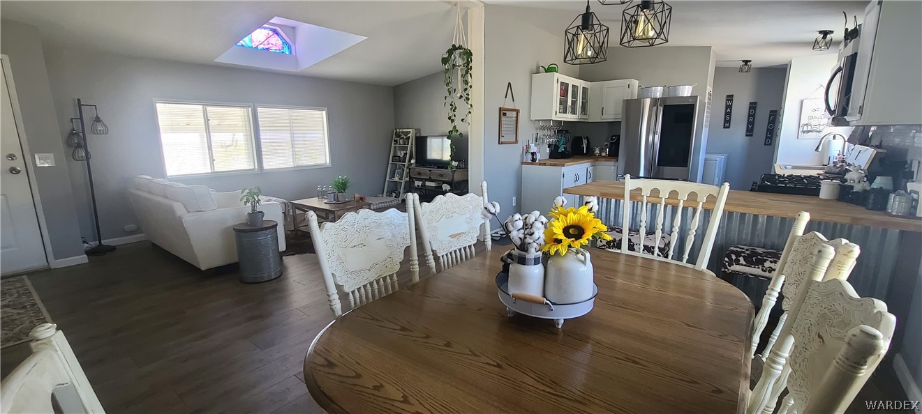 2821 Naco Road Golden Valley, AZ 86413 - Photo 20 of 71 a living room with furniture floor to ceiling window and wooden floor