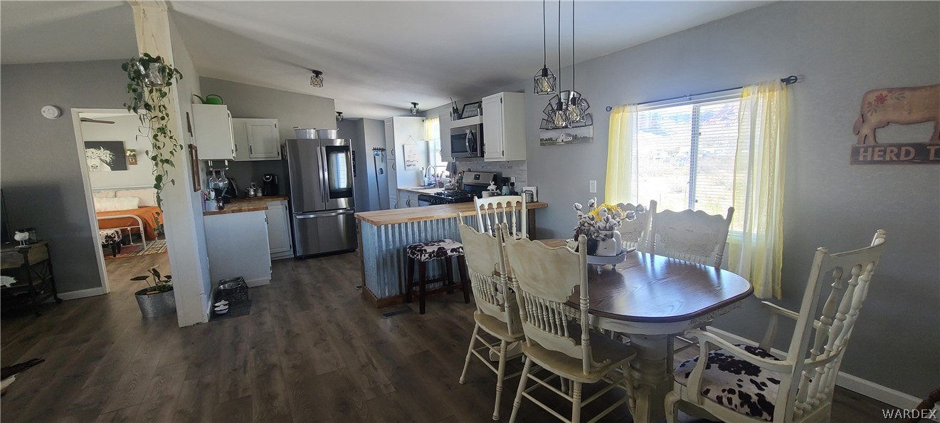 2821 Naco Road Golden Valley, AZ 86413 - Photo 22 of 71 a view of a dining room with furniture window and wooden floor