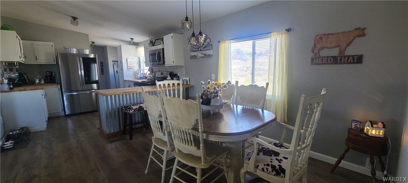 2821 Naco Road Golden Valley, AZ 86413 - Photo 24 of 71 a view of a dining room with furniture window and wooden floor