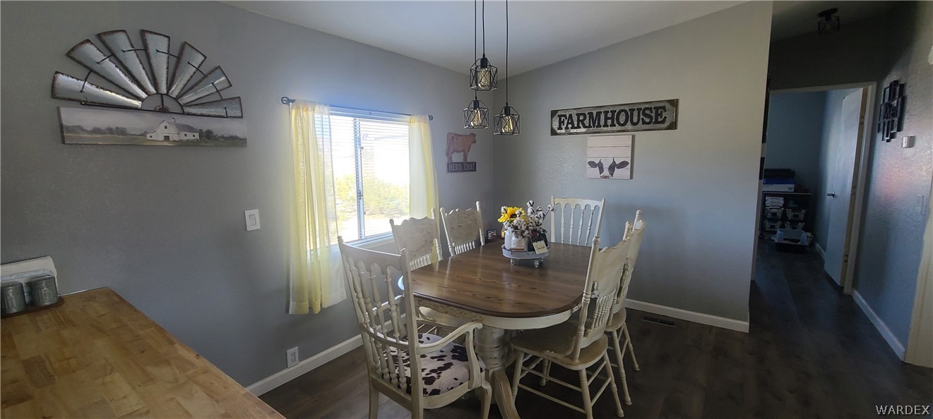 2821 Naco Road Golden Valley, AZ 86413 - Photo 25 of 71 a view of a dining room with furniture and a chandelier