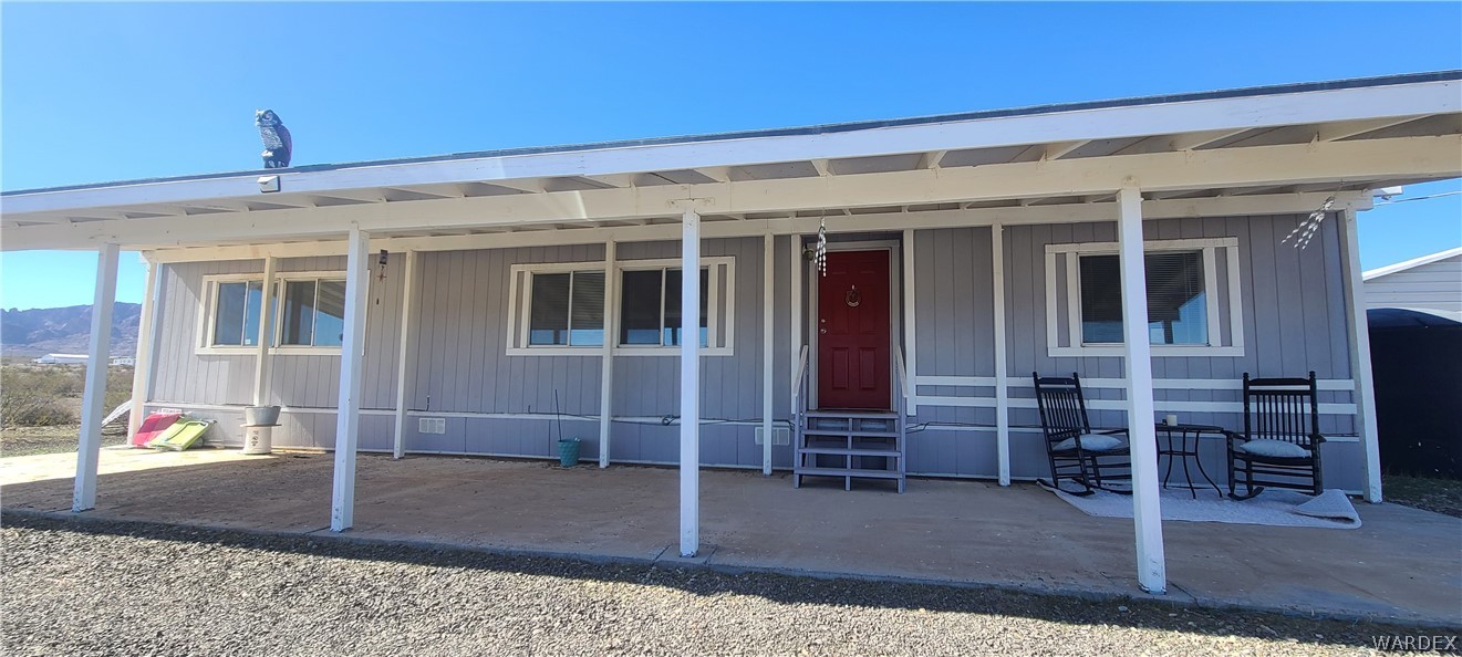 2821 Naco Road Golden Valley, AZ 86413 - Photo 3 of 71 a view of a porch with a table and chairs