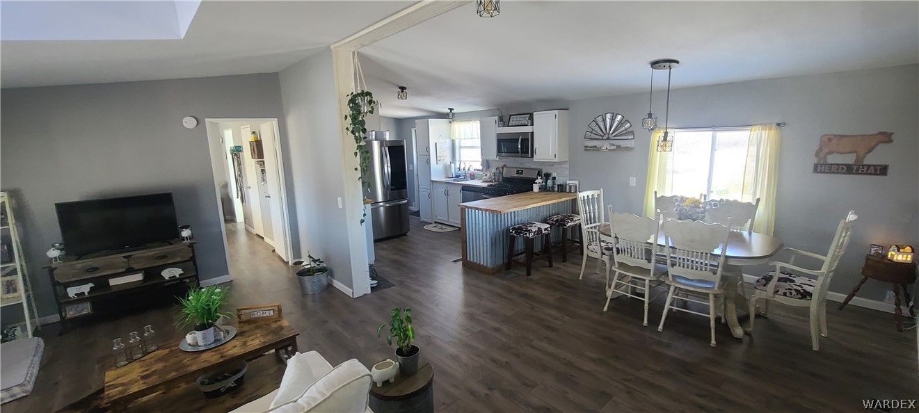 2821 Naco Road Golden Valley, AZ 86413 - Photo 33 of 71 a view of a dining room with furniture window and wooden floor