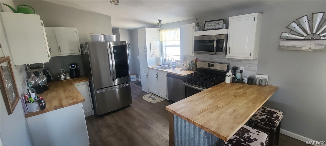 2821 Naco Road Golden Valley, AZ 86413 - Photo 38 of 71 a kitchen with stainless steel appliances granite countertop a refrigerator a stove top oven a sink and dishwasher