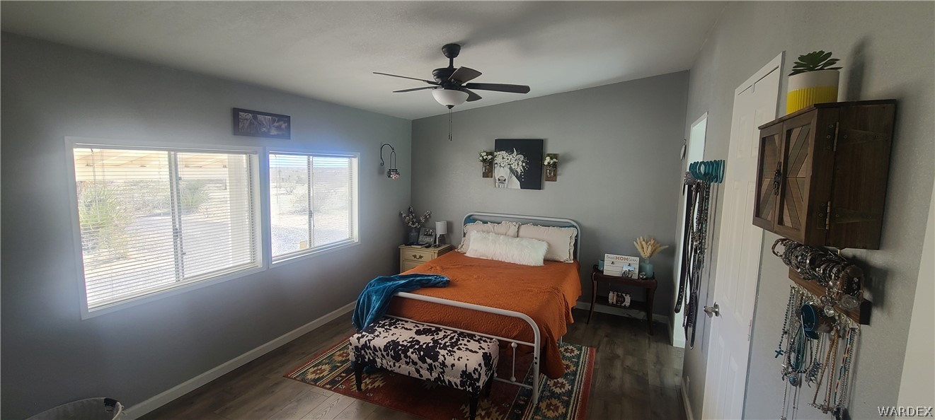 2821 Naco Road Golden Valley, AZ 86413 - Photo 42 of 71 a bedroom with a bed and a flat tv screen