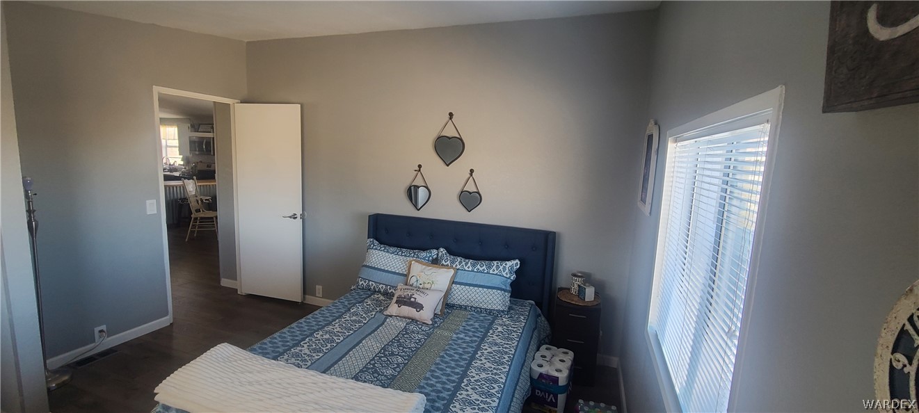 2821 Naco Road Golden Valley, AZ 86413 - Photo 53 of 71 a bedroom with a bed and a mirror