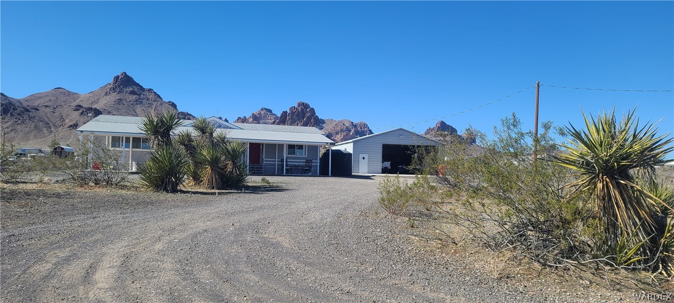 2821 Naco Road Golden Valley, AZ 86413 - Photo 7 of 71 a front view of a house with a yard and garage