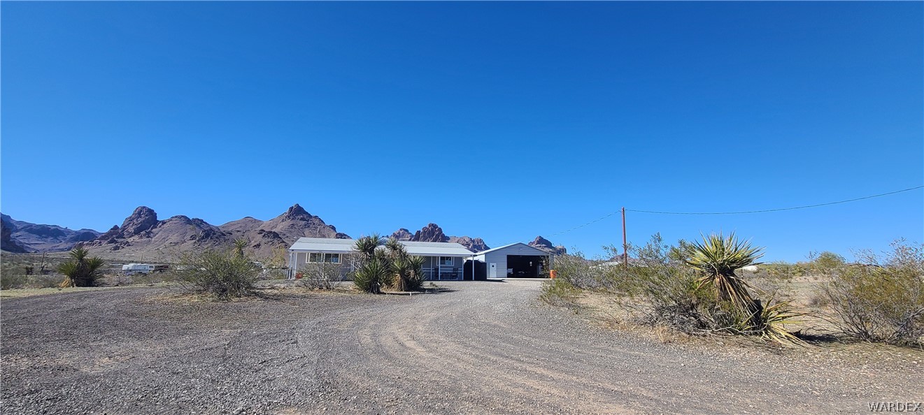 2821 Naco Road Golden Valley, AZ 86413 - Photo 9 of 71 a view of a dry yard with trees