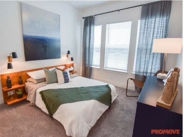 a bathroom with a granite countertop sink a toilet and a mirror