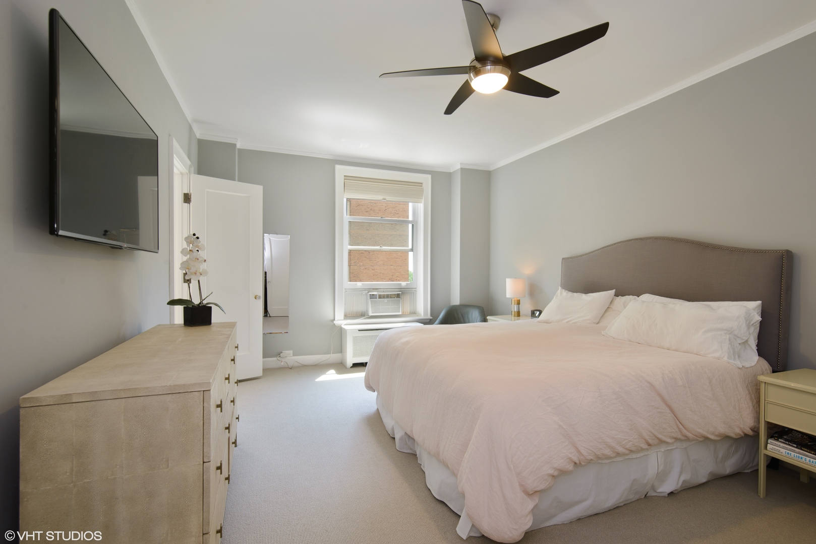 3100 North Sheridan Road, Unit 7D Chicago, IL 60657 - Photo 11 of 24 a bedroom with a bed flat screen tv and a window