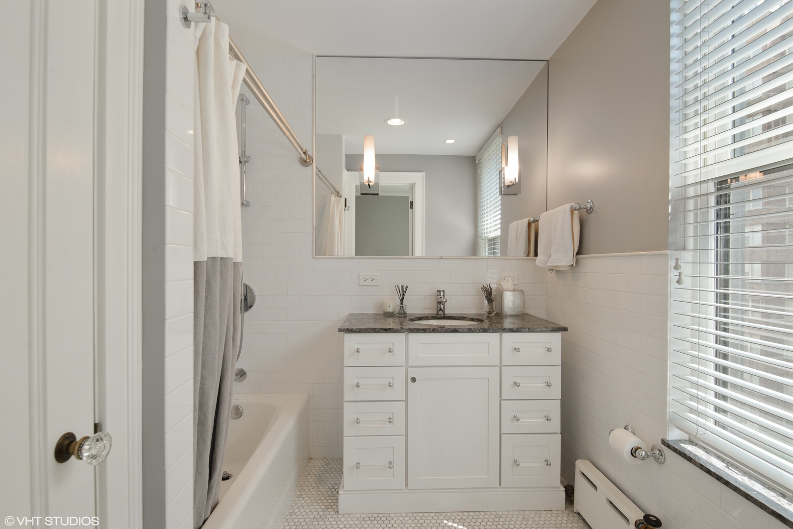 3100 North Sheridan Road, Unit 7D Chicago, IL 60657 - Photo 13 of 24 a bathroom with a granite countertop sink vanity mirror and shower