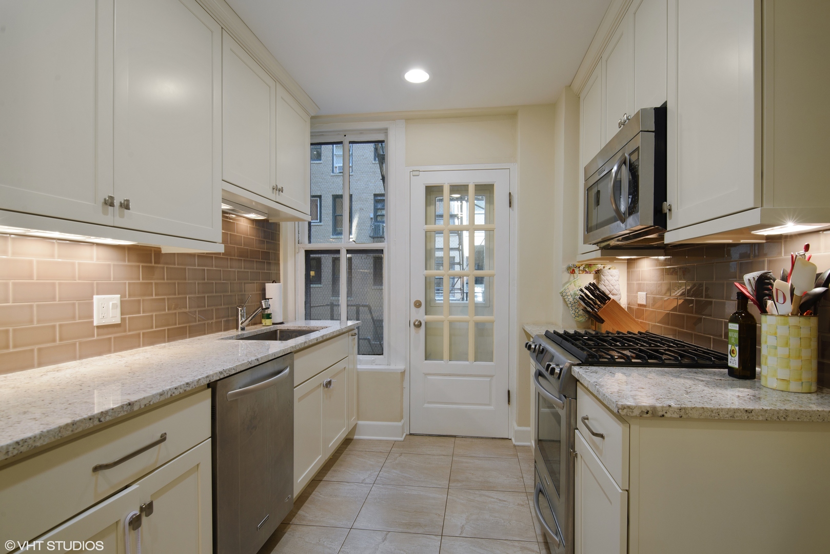 3100 North Sheridan Road, Unit 7D Chicago, IL 60657 - Photo 9 of 24 a kitchen with granite countertop a sink and a stove top oven