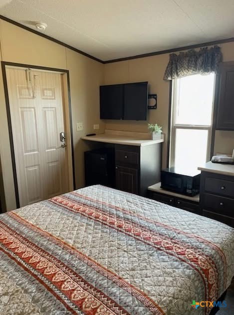 281 County Road 251 Matagorda, TX 77457 - Photo 7 of 9 a bedroom with a bed and a window