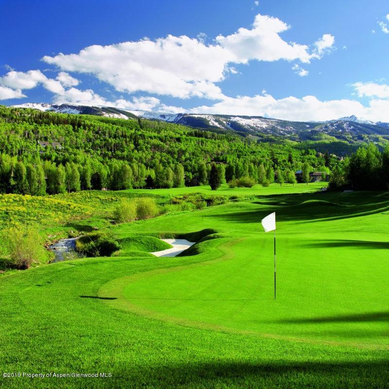 239 Snowmass Club Circle, Unit 111 Snowmass Village, CO 81615 - Photo 22 of 42 a view of a golf course with a lake
