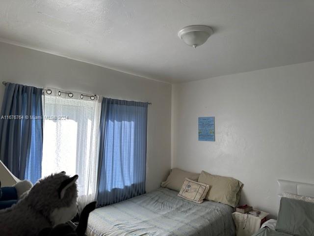 900 Southwest 5th Avenue Miami, FL 33130 - Photo 9 of 10 a bed room with a bed and a window