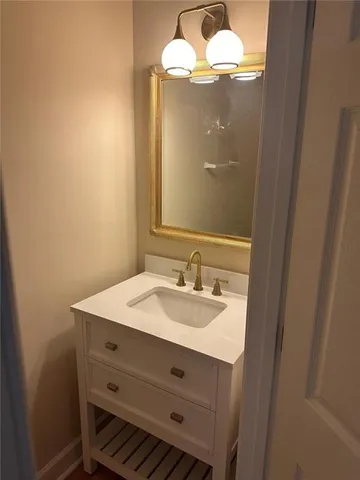 a bathroom with a sink vanity and a mirror