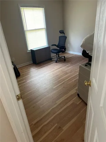 a room with wooden floor and furniture