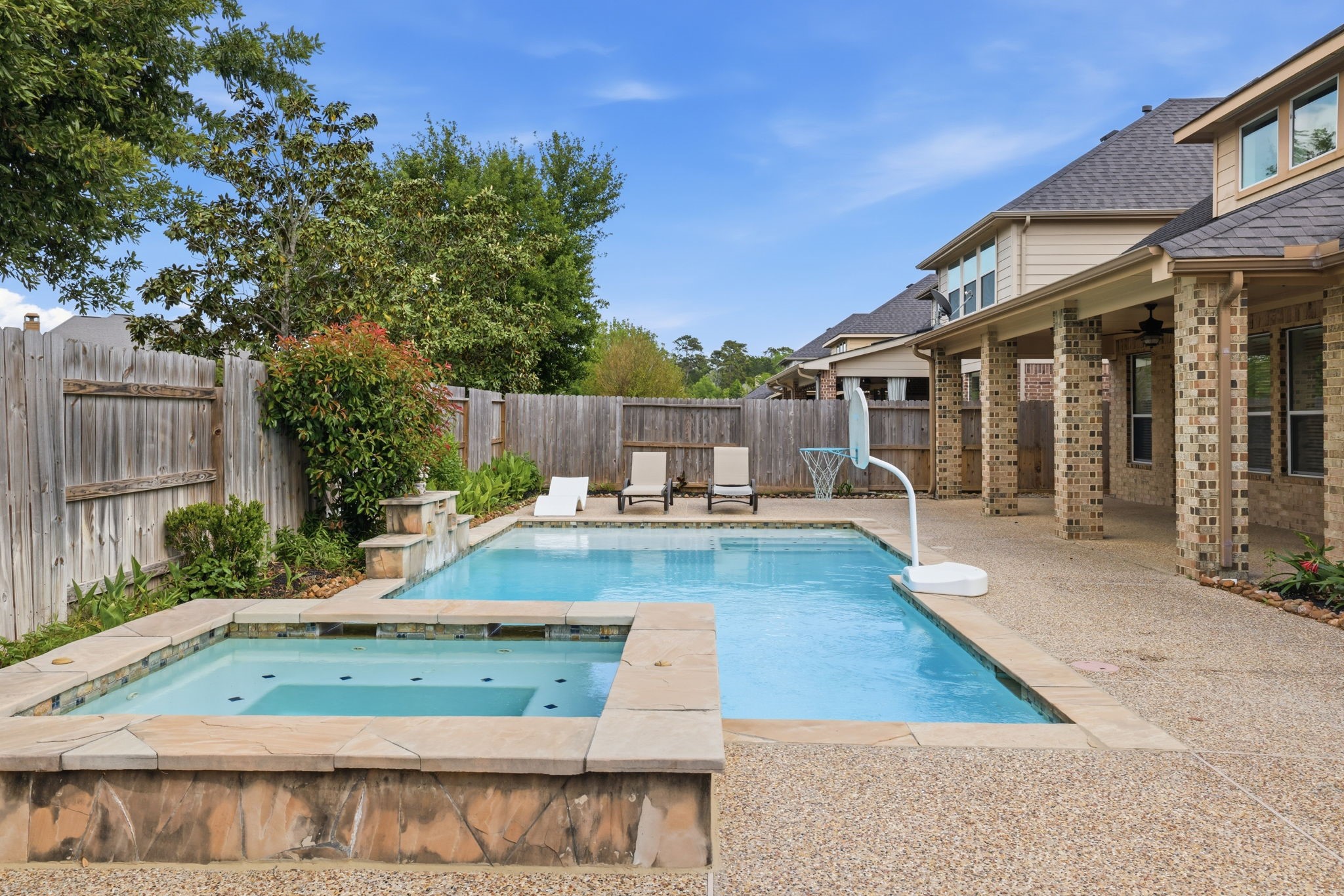 8169 Tranquil Lake Way Conroe, TX 77385 - Photo 17 of 26 a view of a patio with chairs and a table
