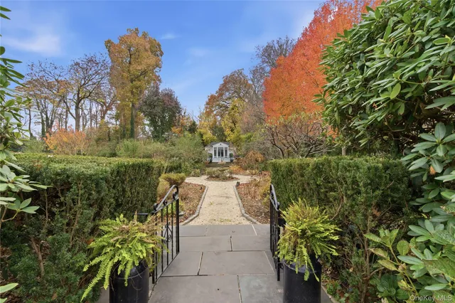 a small yard with fountain and flowers