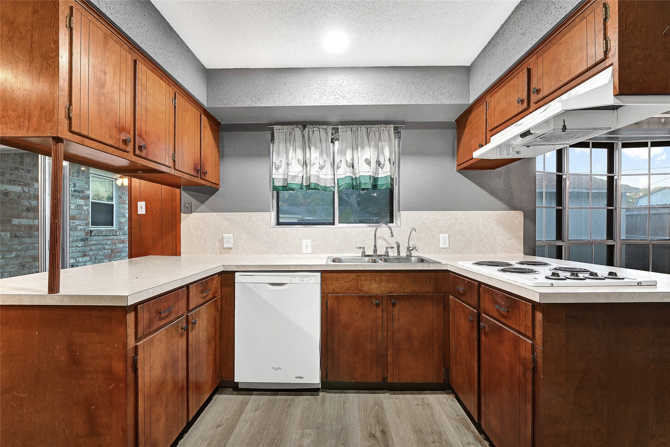 1712 Redwood Circle Alvin, TX 77511 - Photo 11 of 23 a kitchen with a sink stove and cabinets