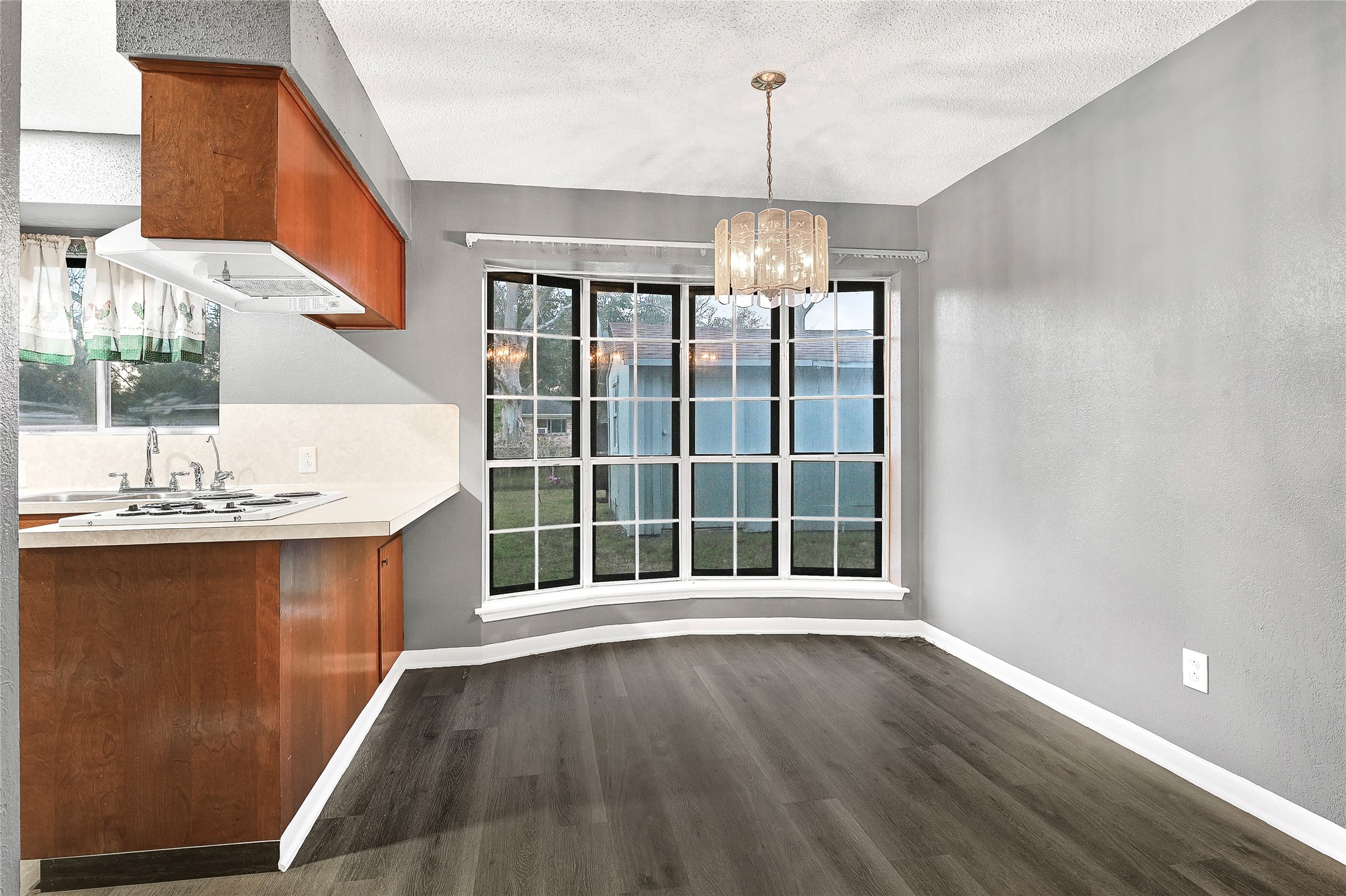 1712 Redwood Circle Alvin, TX 77511 - Photo 13 of 23 a view of an empty room with wooden floor and a window