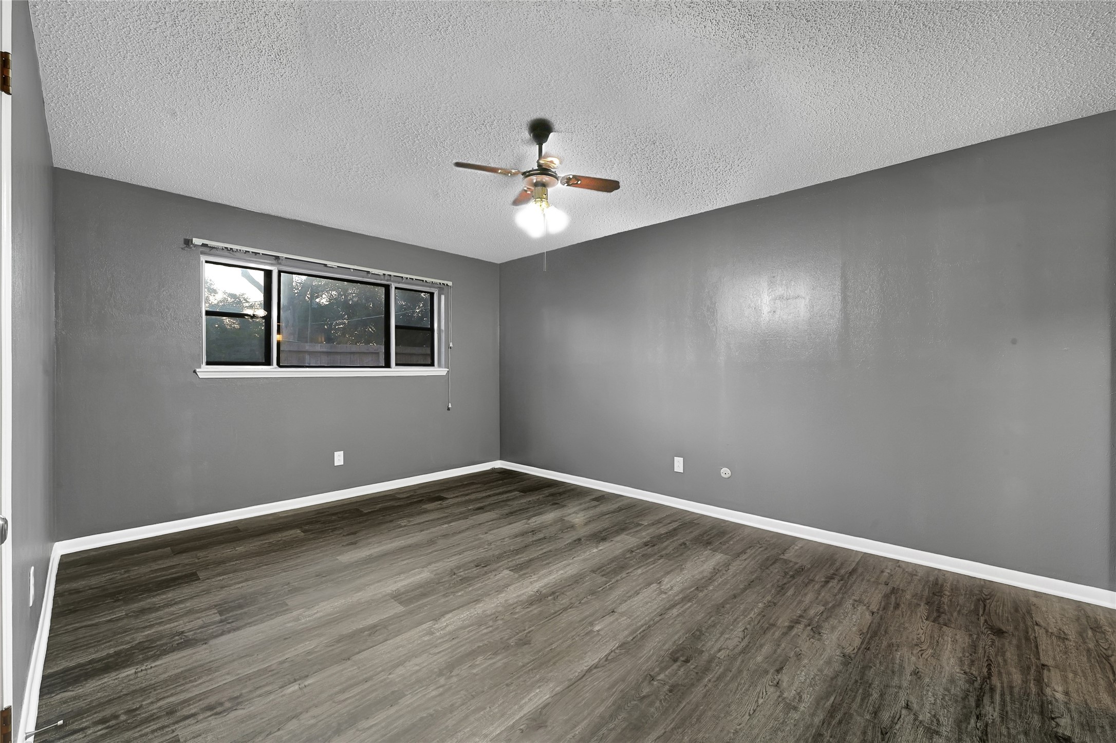 1712 Redwood Circle Alvin, TX 77511 - Photo 15 of 23 wooden floor in an empty room with a window