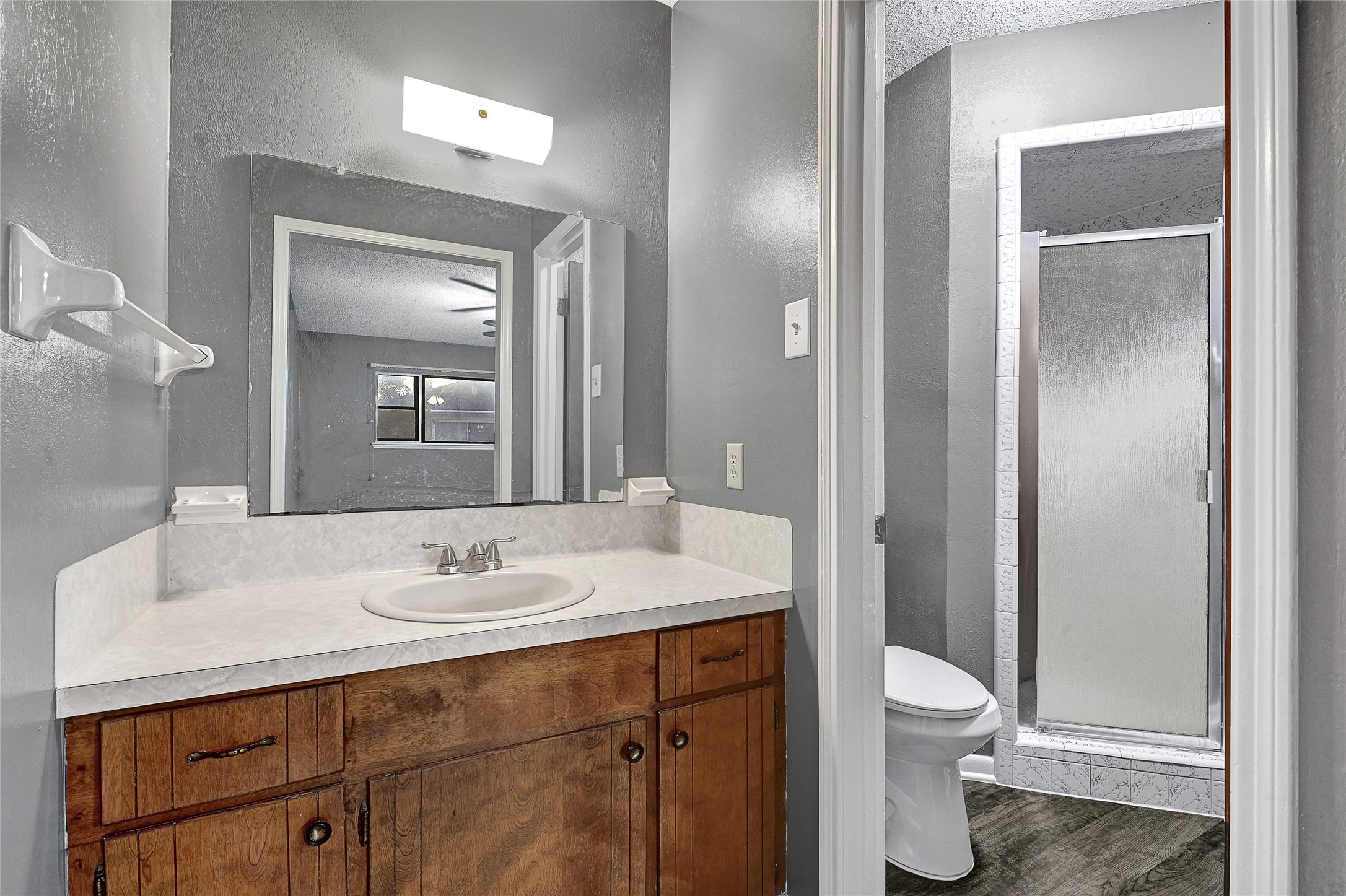 1712 Redwood Circle Alvin, TX 77511 - Photo 17 of 23 a bathroom with a sink toilet and shower