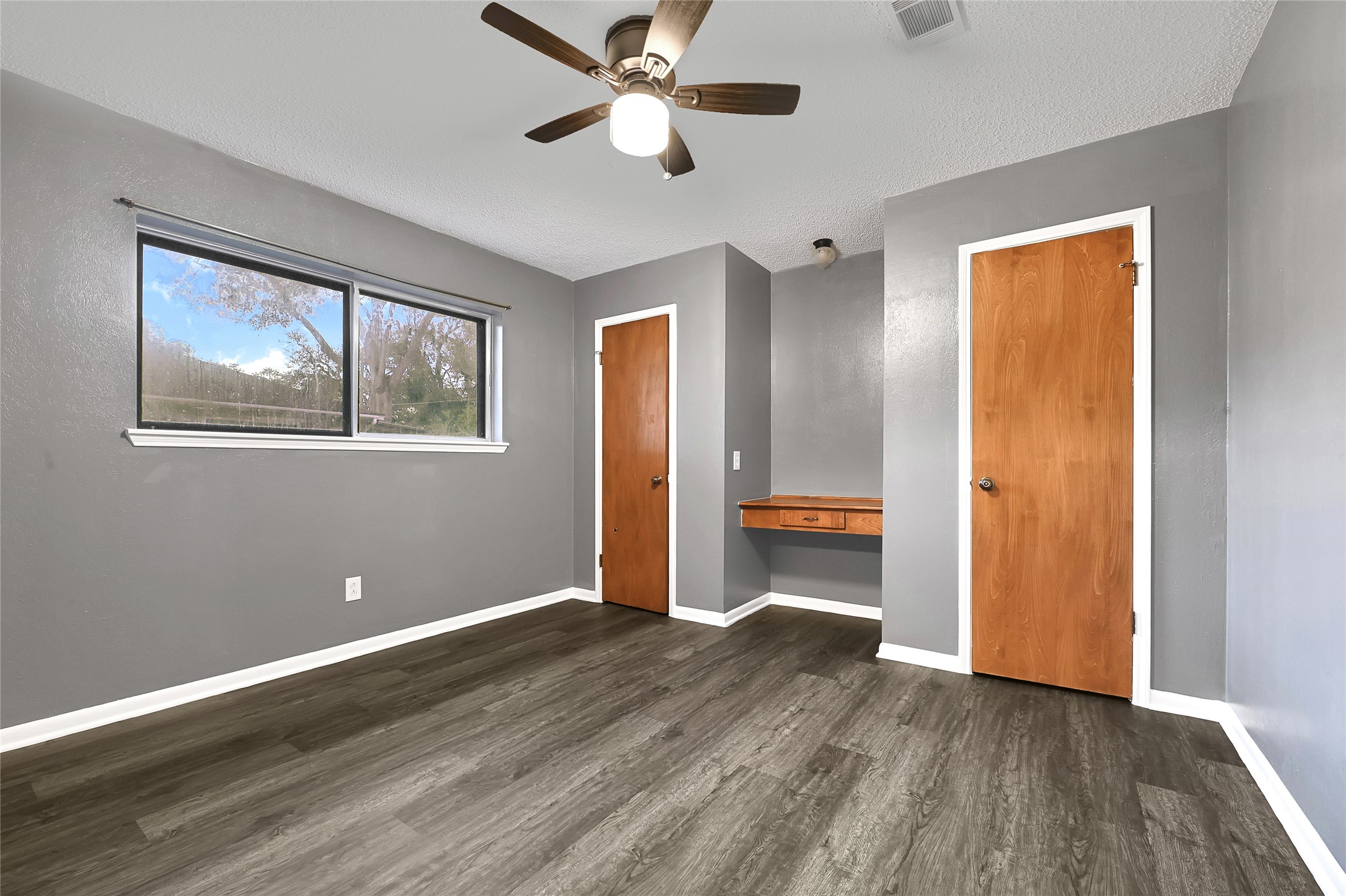 1712 Redwood Circle Alvin, TX 77511 - Photo 23 of 23 a view of empty room with wooden floor and ceiling fan