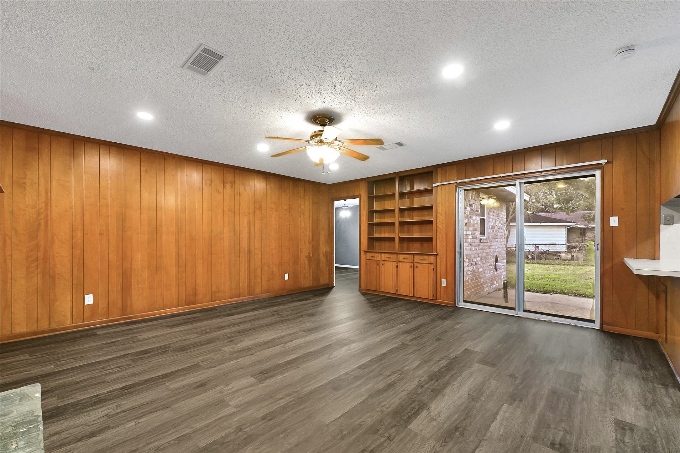 1712 Redwood Circle Alvin, TX 77511 - Photo 7 of 23 a view of an empty room with a window and wooden floor