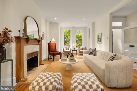 a living room with furniture and fireplace