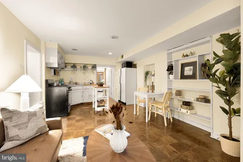 a living room with furniture and a chandelier