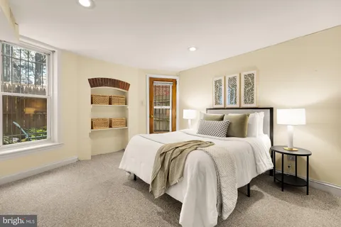 a spacious bedroom with a bed and a large window