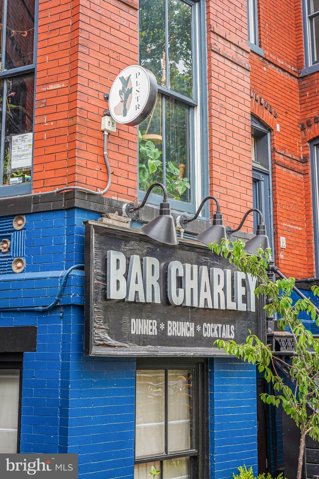 1735 Riggs Place Northwest Washington, DC 20009 - Photo 26 of 35 a view of sign board with buildings in the background