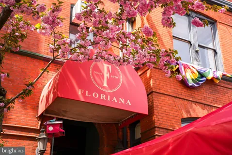 a sign that is on a wall next to a building