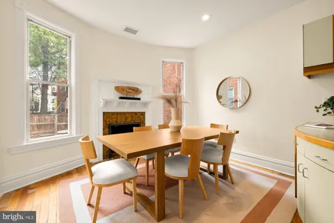 a dining room with furniture and window