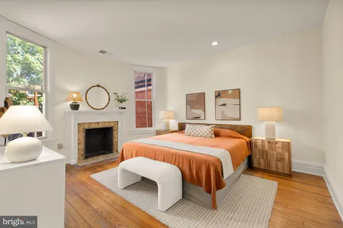 a bedroom with bed and a fireplace