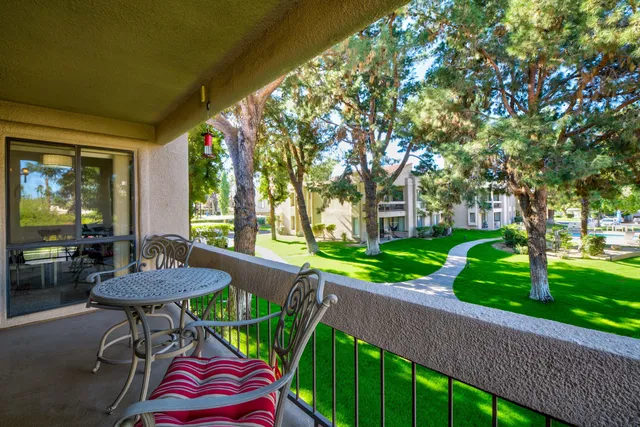 a view of a chairs and table in patio with a yard
