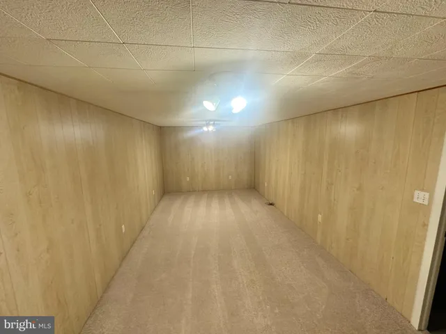 a view of empty room with wooden walls