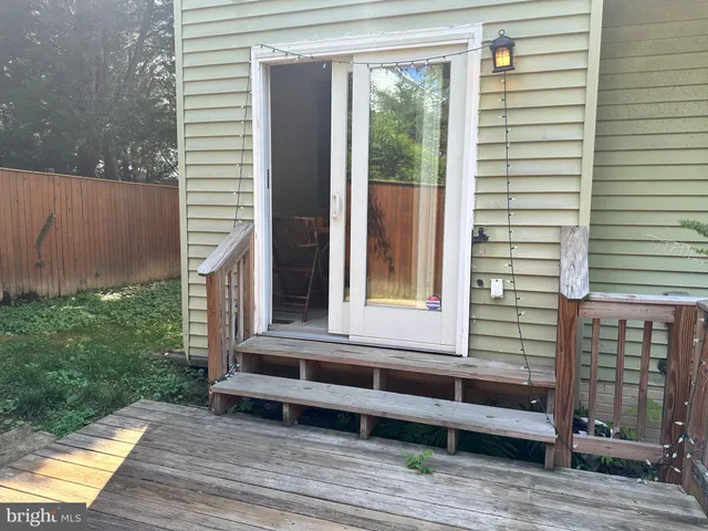 a view of a backyard with wooden fence