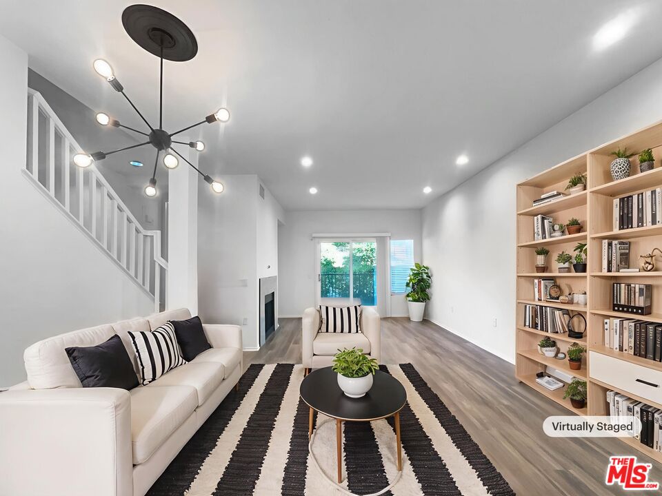20000 Plum Canyon Road, Unit 1815 Santa Clarita, CA 91350 - Photo 2 of 21 a living room with furniture a rug and a bookshelf