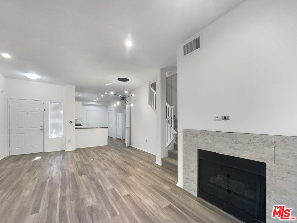 20000 Plum Canyon Road, Unit 1815 Santa Clarita, CA 91350 - Photo 3 of 21 a view of a livingroom with wooden floor and a fireplace