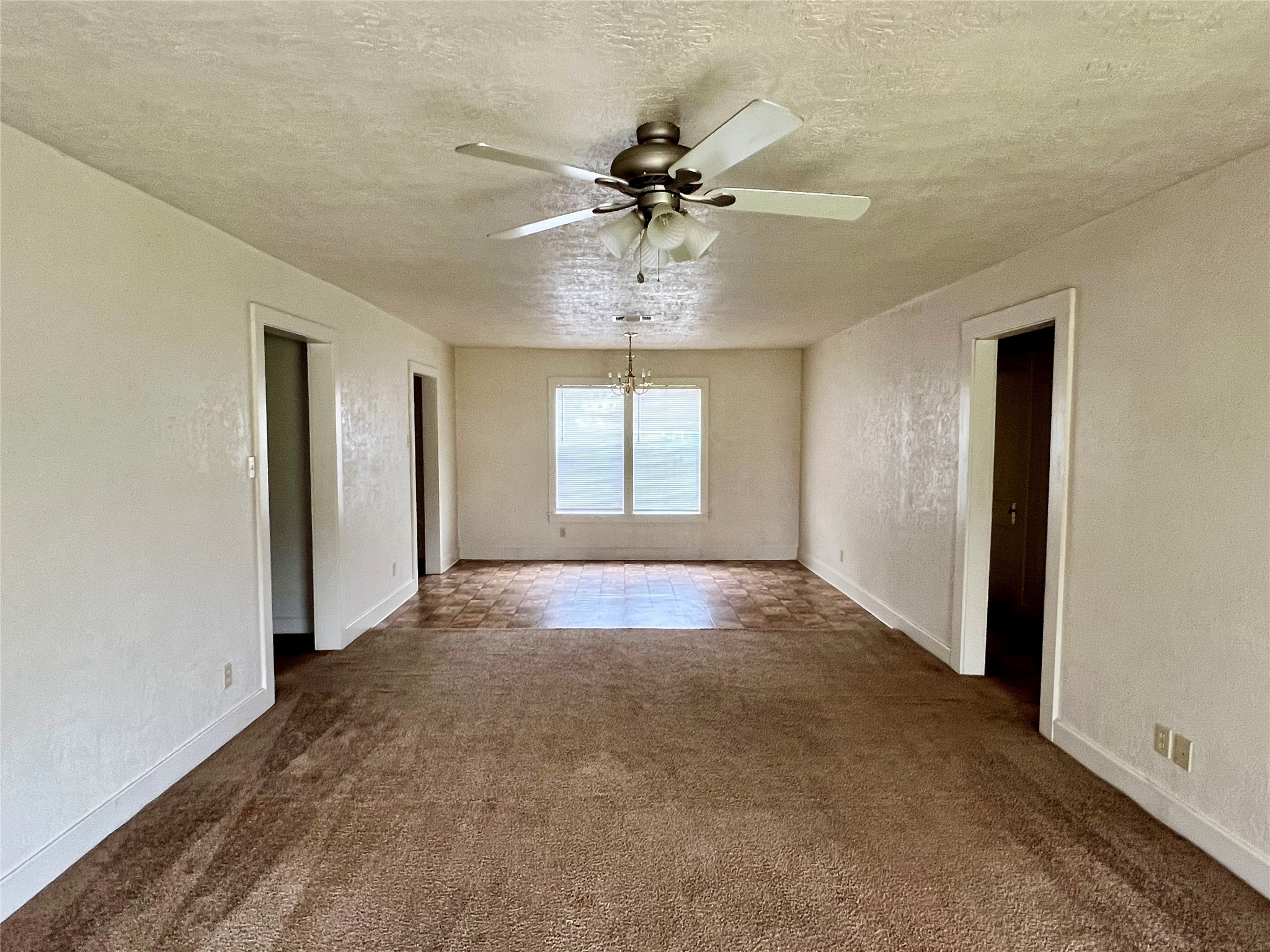 502 West Third Street Brenham, TX 77833 - Photo 2 of 6 an empty room with chandelier fan and windows