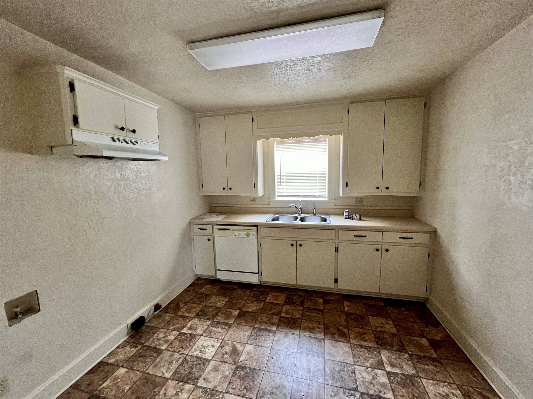 502 West Third Street Brenham, TX 77833 - Photo 3 of 6 a room with granite countertop white cabinets and window
