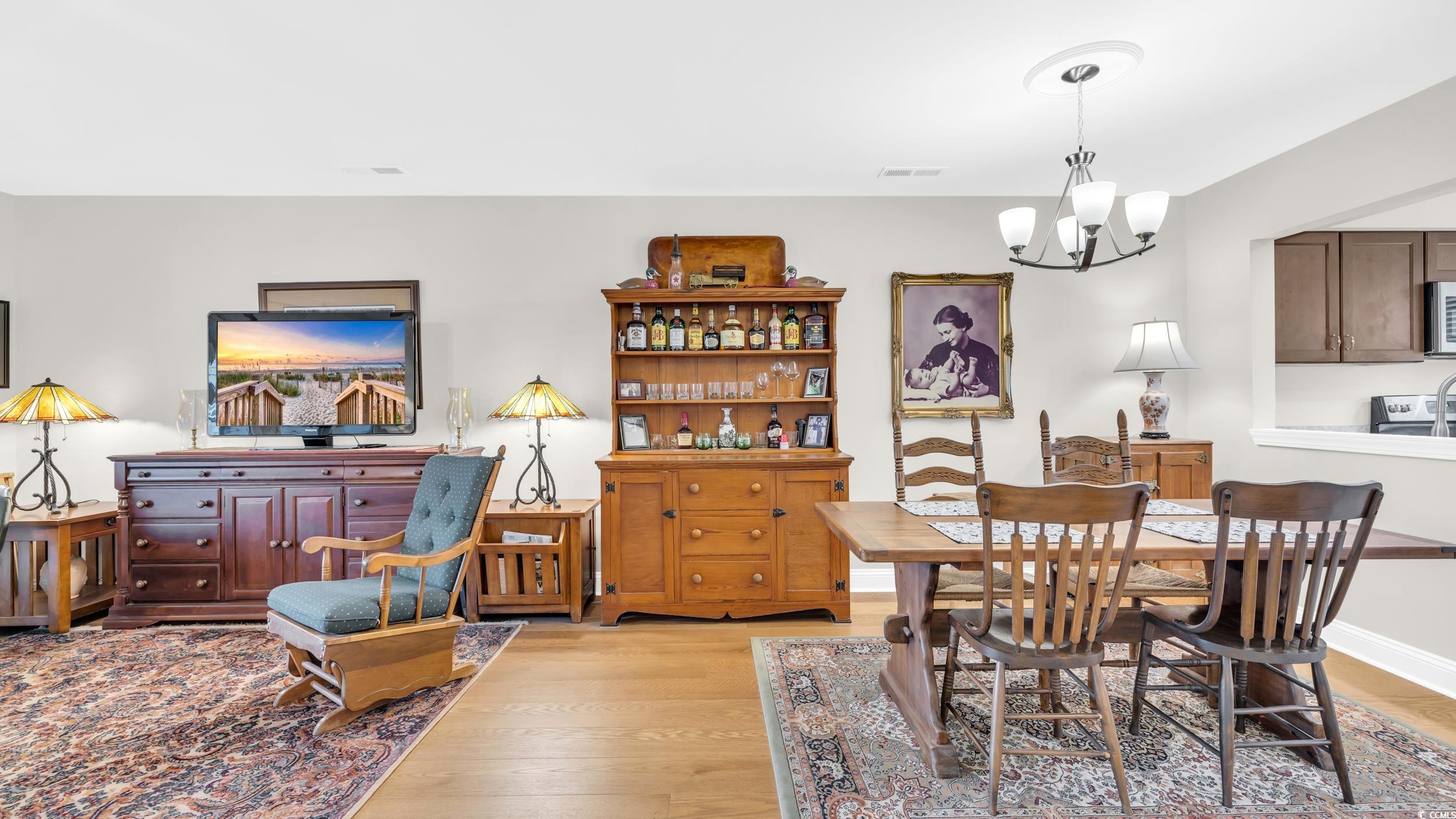 5137 Highway 17 Business, Unit 2B Murrells Inlet, SC 29576 - Photo 14 of 32 Dining room with light wood finished floors and a chandelier