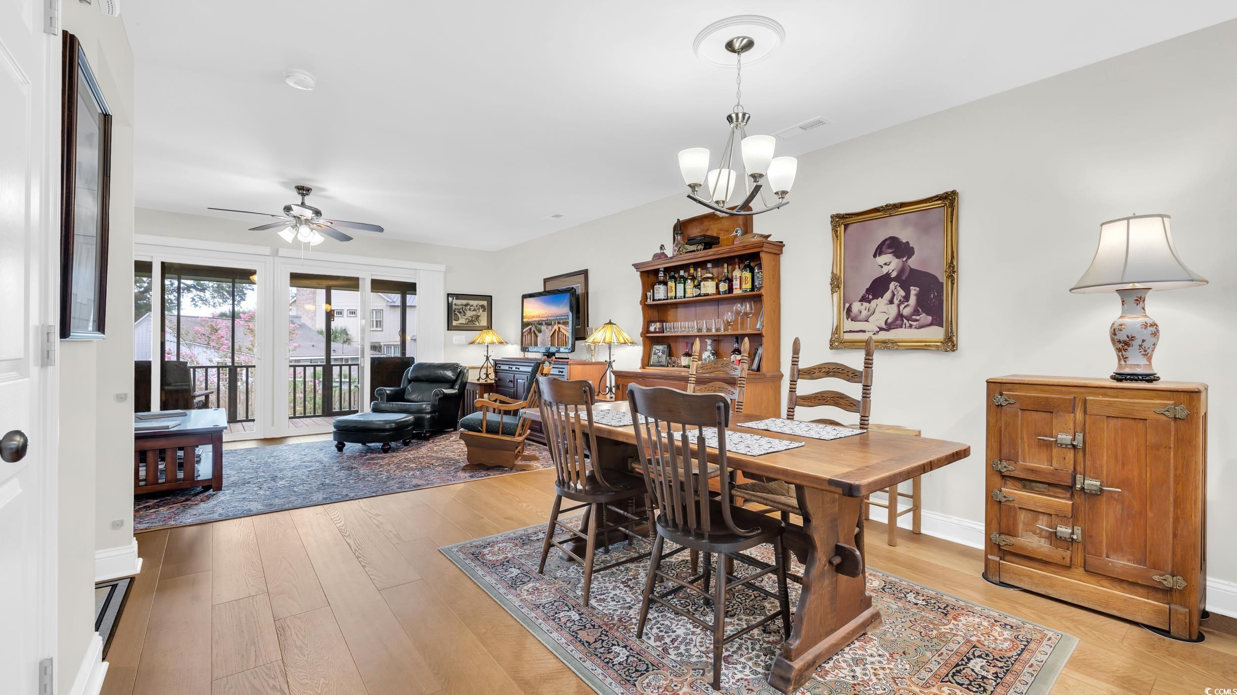 5137 Highway 17 Business, Unit 2B Murrells Inlet, SC 29576 - Photo 15 of 32 Dining area featuring light wood finished floors, a chandelier, and ceiling fan