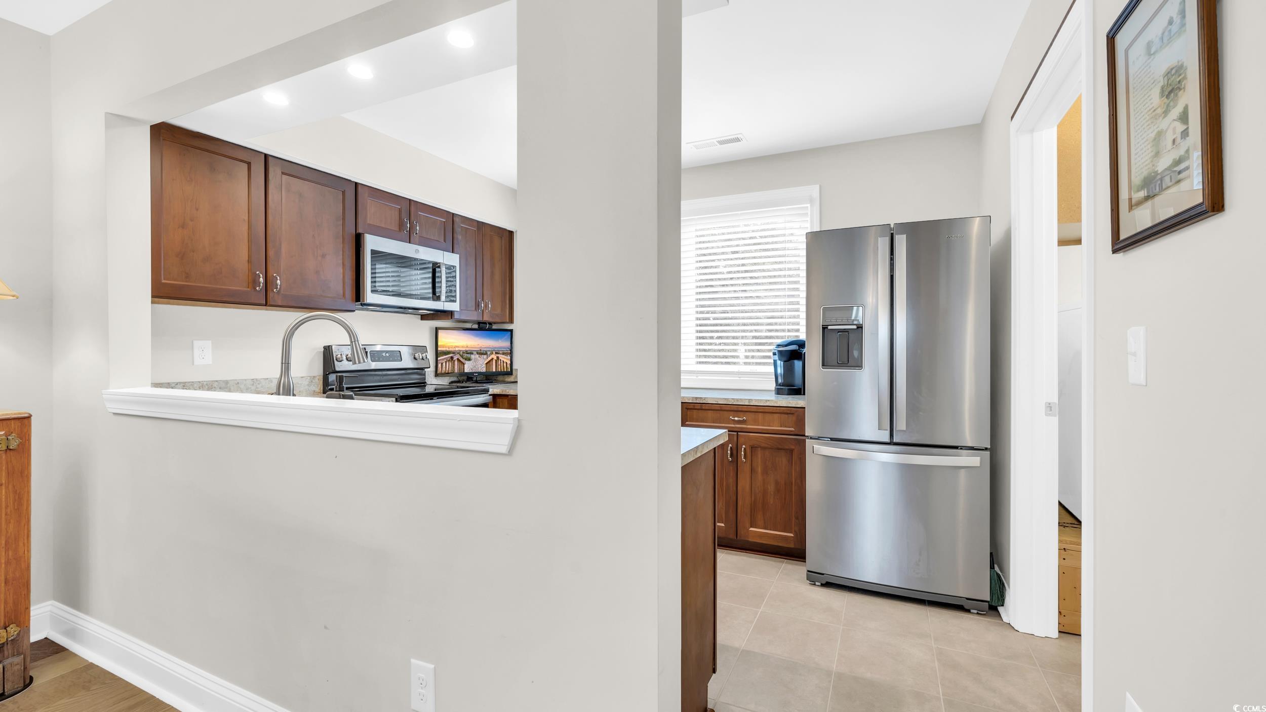 5137 Highway 17 Business, Unit 2B Murrells Inlet, SC 29576 - Photo 18 of 32 Kitchen with appliances with stainless steel finishes, light countertops, brown cabinetry, light tile patterned floors, and recessed lighting