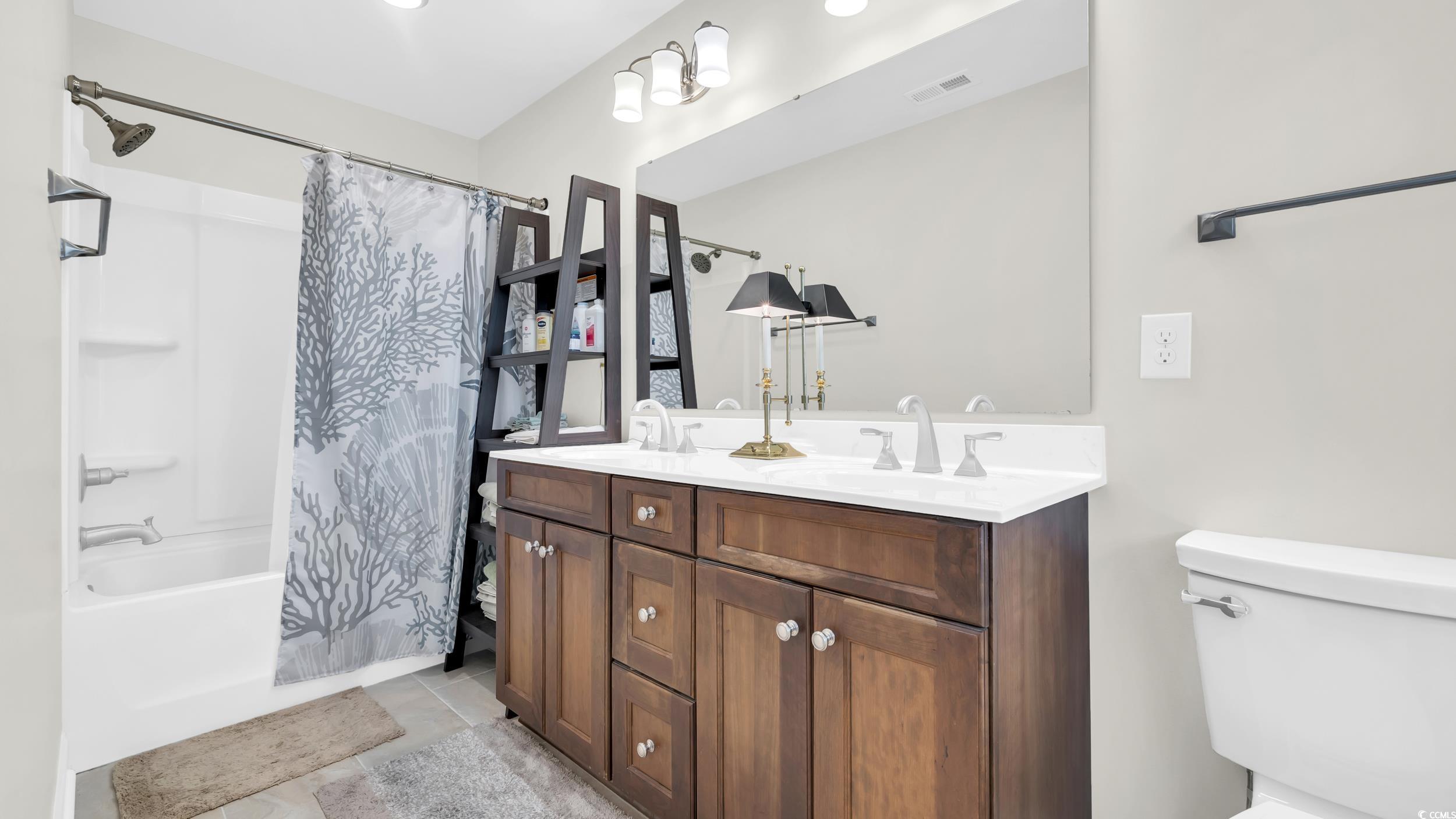 5137 Highway 17 Business, Unit 2B Murrells Inlet, SC 29576 - Photo 22 of 32 Full bath with shower / bath combo with shower curtain, double vanity, and light tile patterned floors
