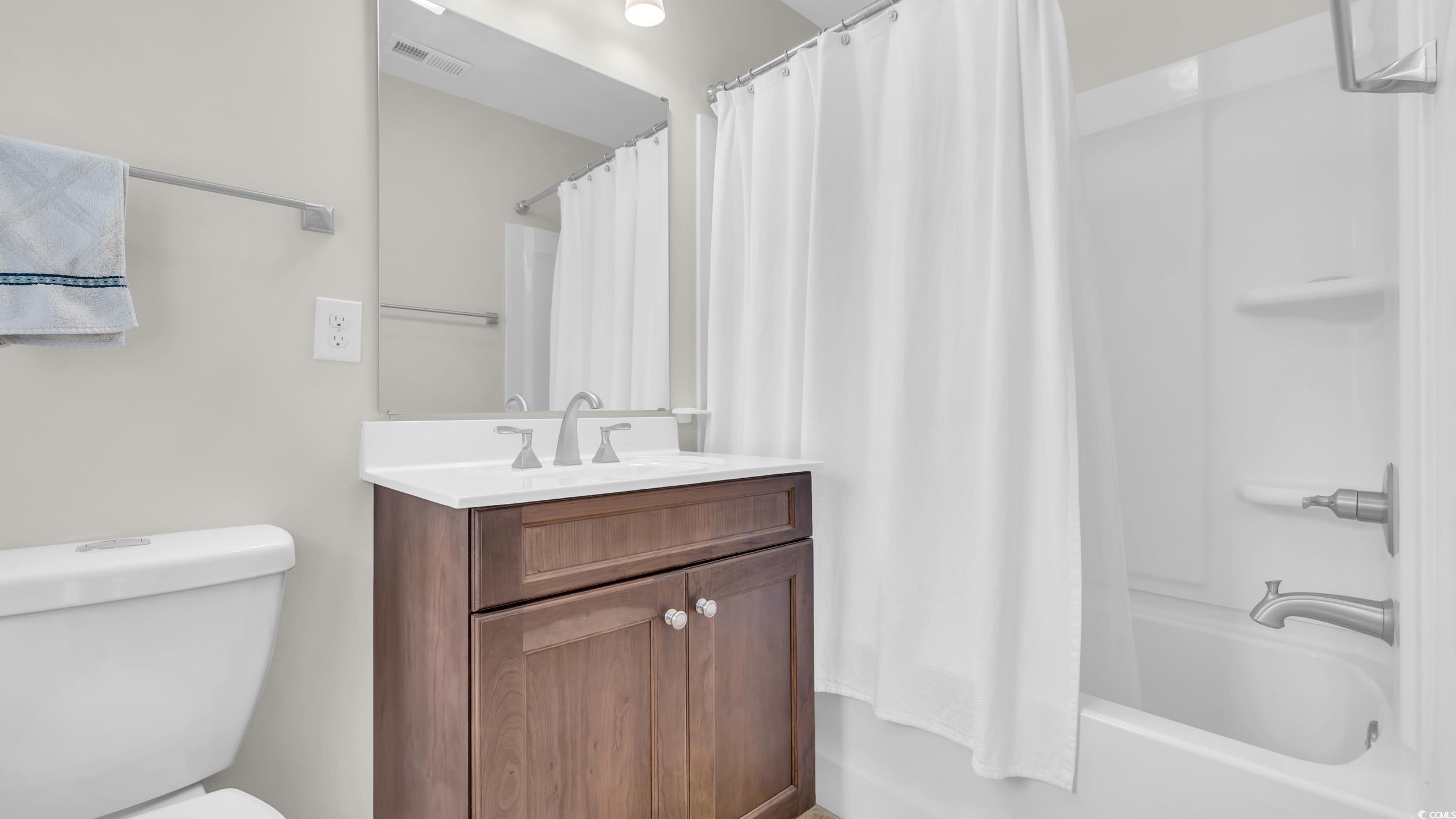 5137 Highway 17 Business, Unit 2B Murrells Inlet, SC 29576 - Photo 24 of 32 Bathroom featuring shower / bathtub combination with curtain and vanity