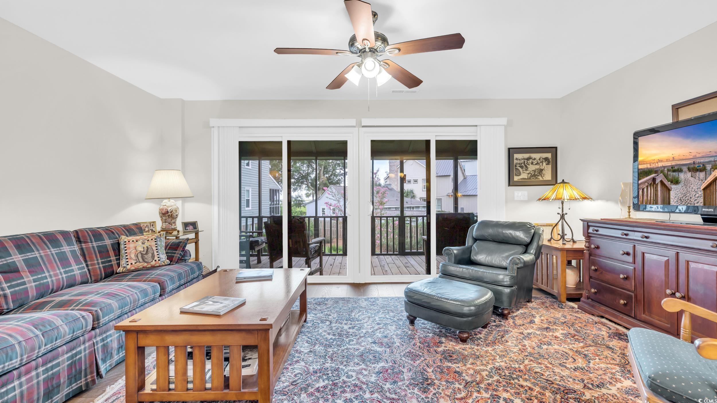 5137 Highway 17 Business, Unit 2B Murrells Inlet, SC 29576 - Photo 8 of 32 Living area with wood finished floors and a ceiling fan